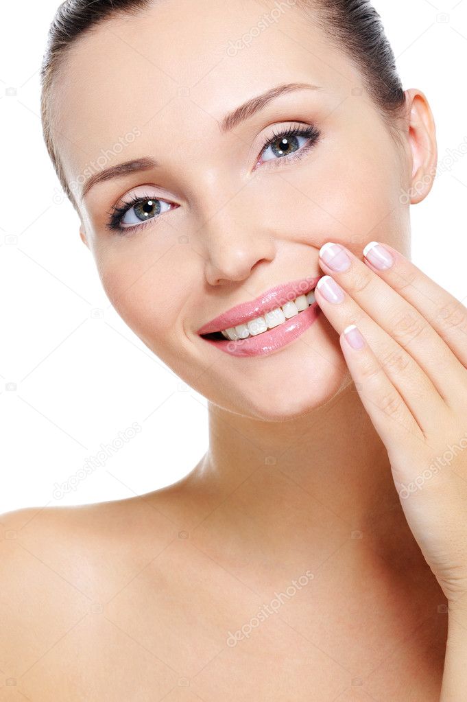 Portrait of Pretty smiling young woman with hand at lips over white 