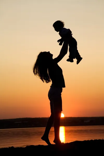 Mother and daughter on sunset