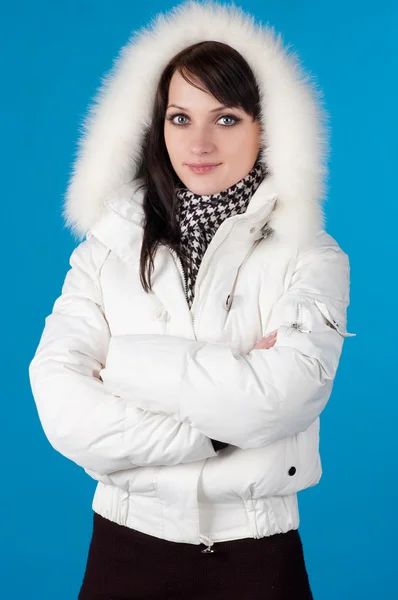 Woman in winter clothes. On blue