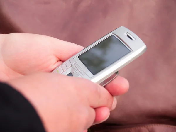 Human hands holding a cell phone