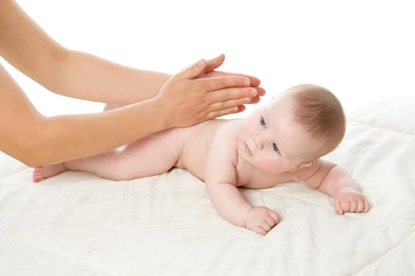 The feminine hands massage the baby boy
