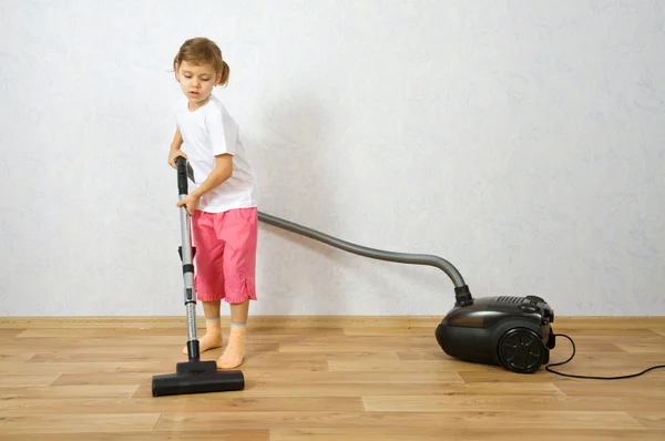 Little girl with vacuum cleaner