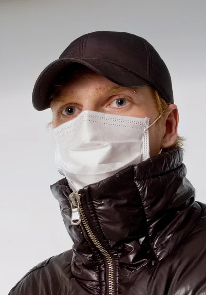 Young man in a medical mask flu