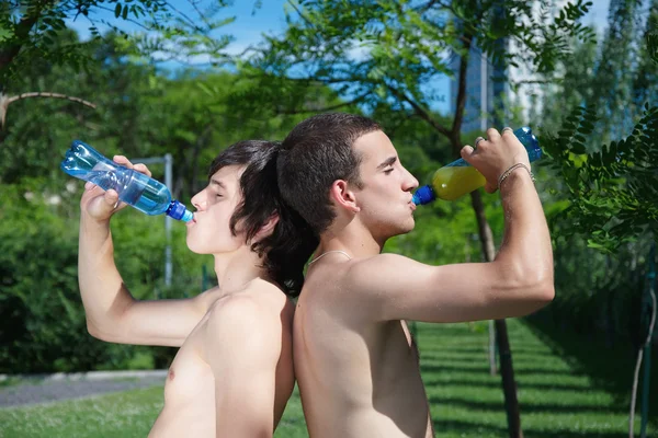 Two guys drink water