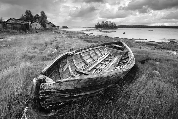 Old fishing unpainted wooden boat ashore