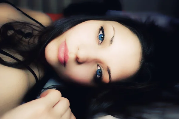 Beautiful lying woman with blue eyes