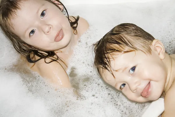 Two children bathe in the bath