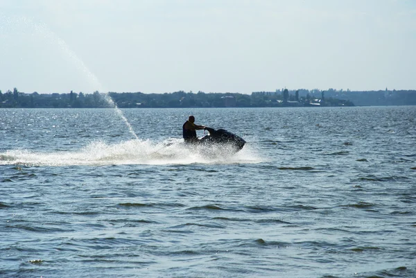 Backlit jet ski with water spray