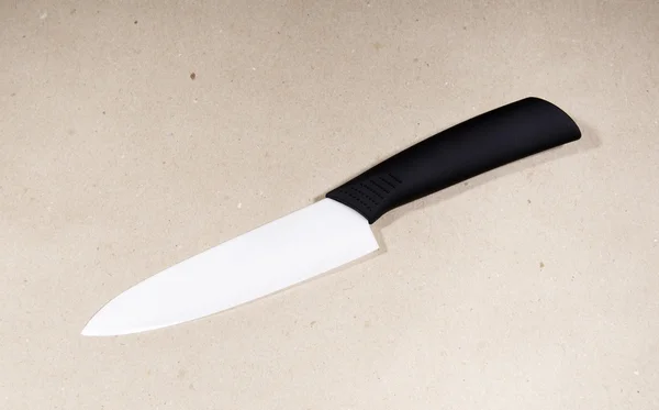 White ceramic knife on draft paper