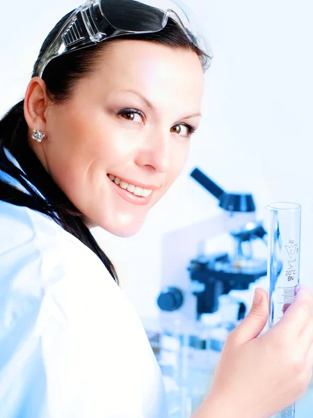 Female researcher holding up a test tube