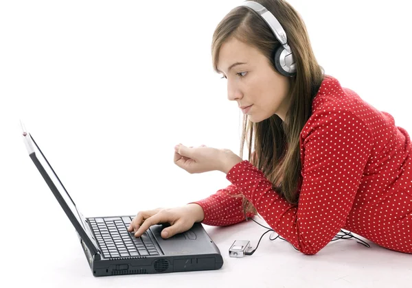 Girl working on laptop and listening mp3