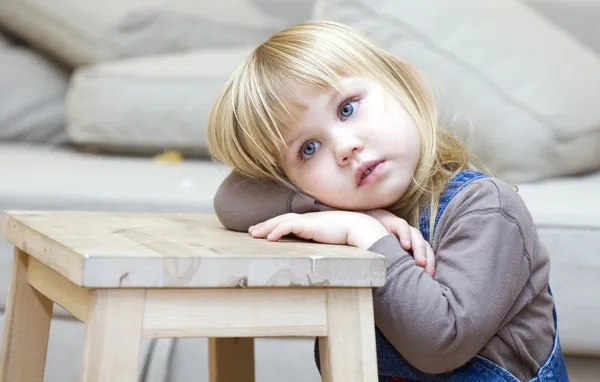 Sitting little girl with blond hair