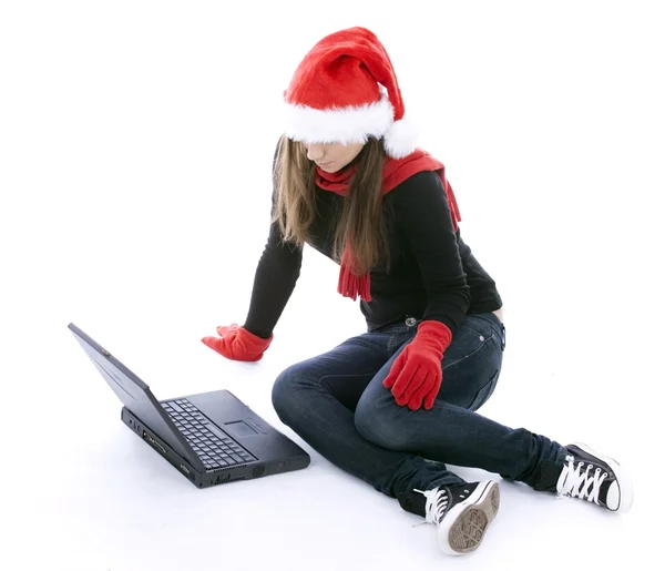 Woman in santa hat working on laptop