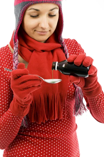 Young woman with spoon of syrup