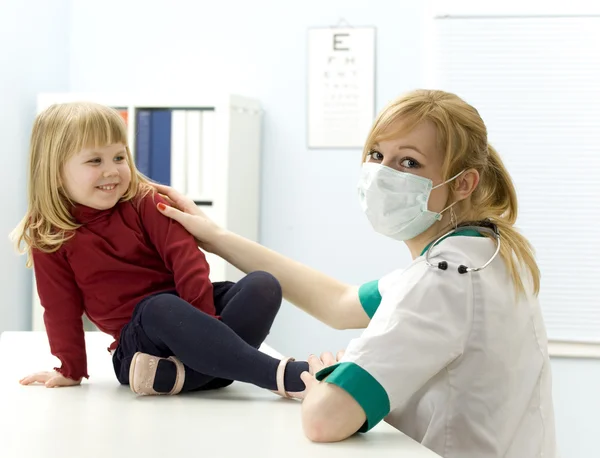 Happy little girl at female doctor