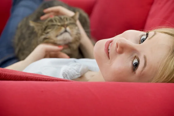 Lying young woman with cat