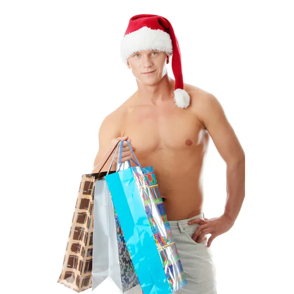 Sexy muscular shirtless man in Santa Claus hat