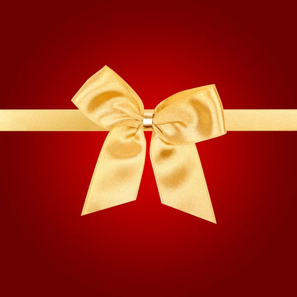 Gold Christmas bow on red card
