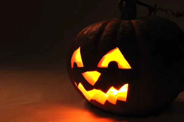 The carved face of pumpkin glowing on Ha — Stock Photo #1834445