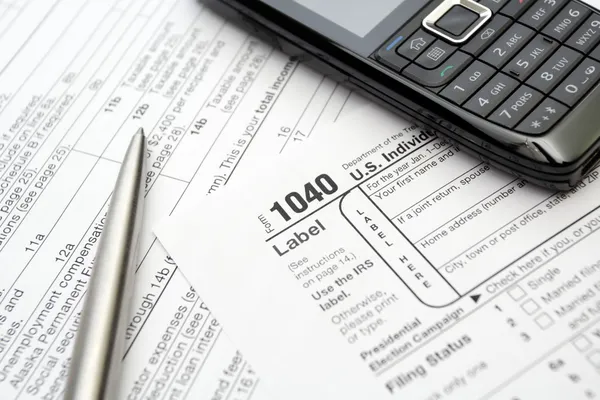 Mobile phone and pen on tax forms