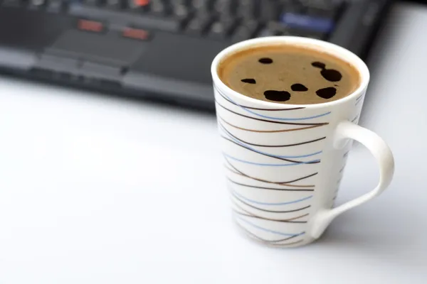 Coffee brake with laptop on a desk