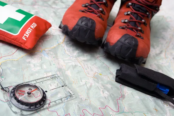 Hiking shoes and equipment on map