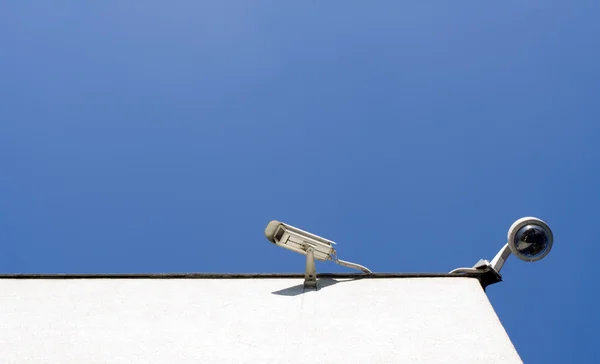 Security cameras and clear blue sky