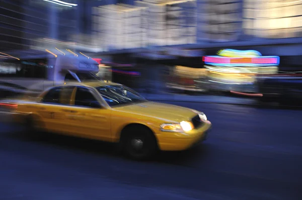Taxicab speeding down street at night