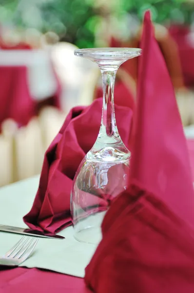 Restaurant table with empty wine glass