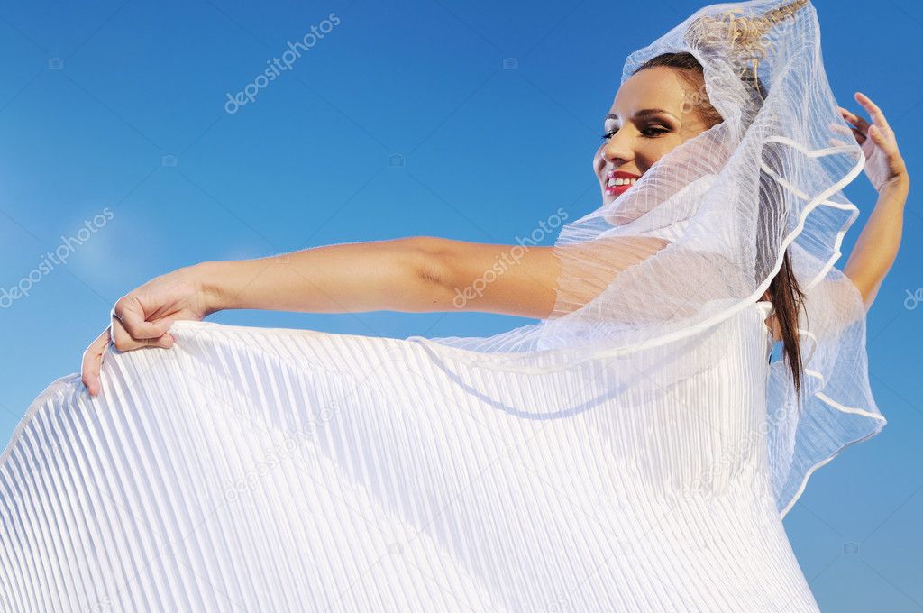 Happy young beautiful bride after wedding ceremony event have fun on meadow
