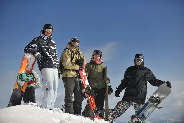 Snowboarders relaxing and enjoy sun