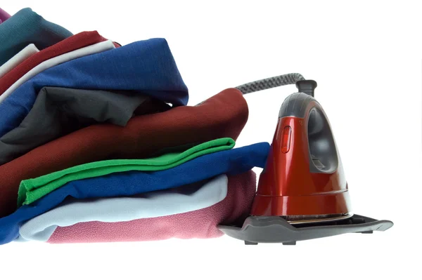 Isolated steam iron and stack shirts