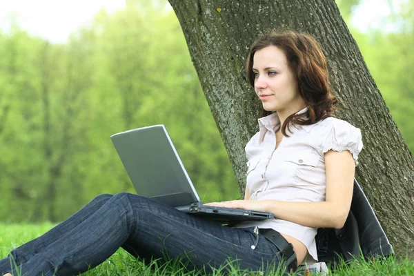 The girl with laptop on the nature