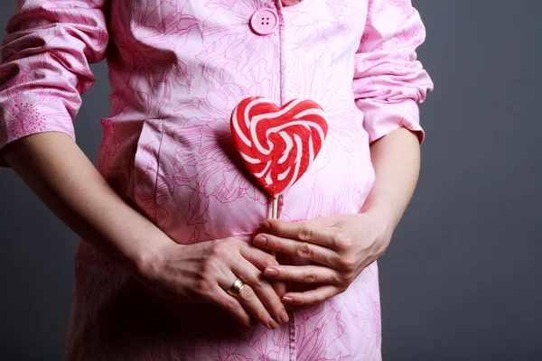 Pregnant woman with big lollipop