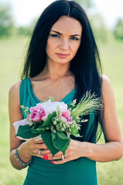 Beautiful young woman with bouquet