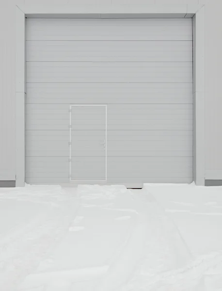 Simple metal door in gray wall