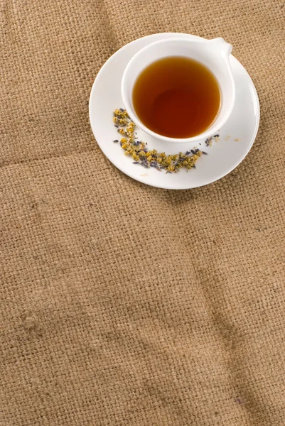 Red tea and burlap background
