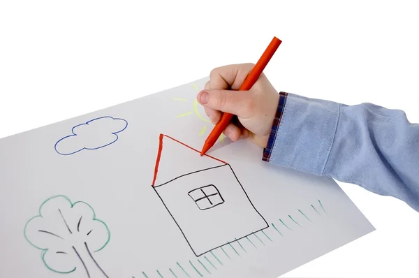 Child hand drawing a picture on a sheet