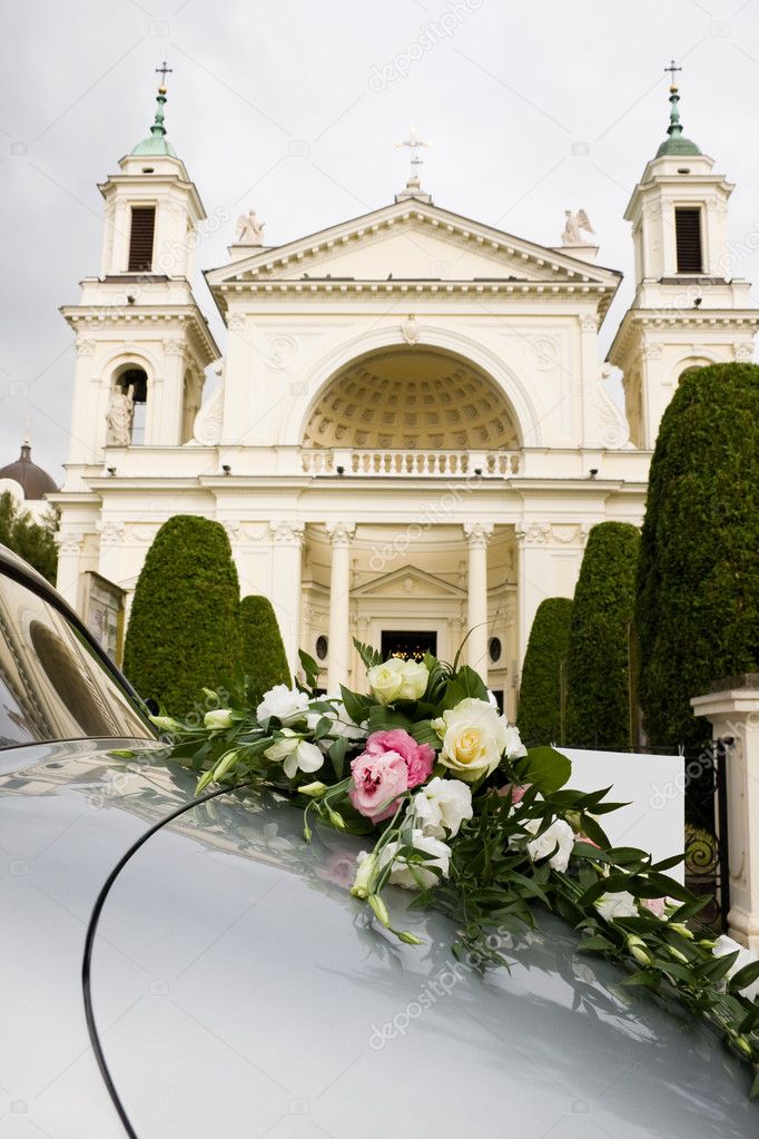 Luxury wedding car decorated by rose flowers Church in Wilanow in a 