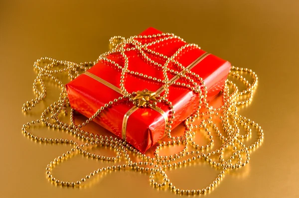 Red gift on gold background