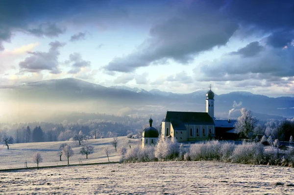 Alpine scenery with church in the frosty