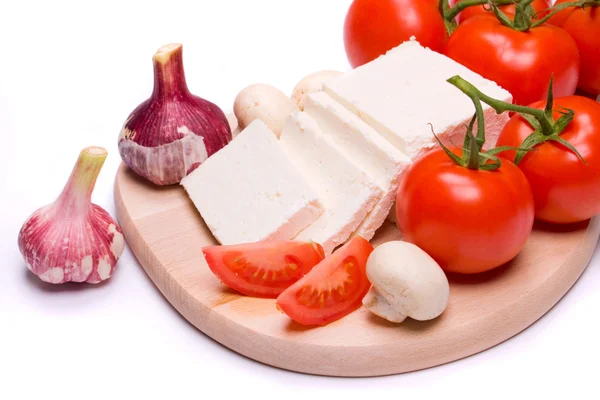 Cheese and tomato on white background