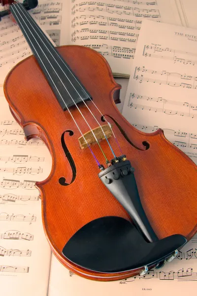 Violin resting on music scores