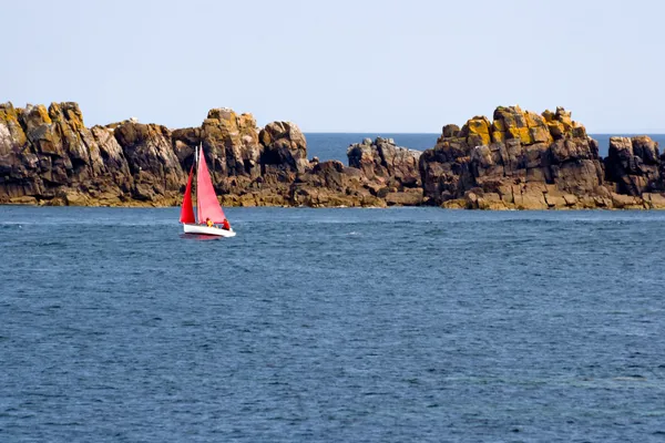 Red sailboat in the Atlantic Ocean