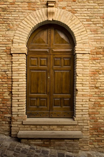 Wooden door in stone archway