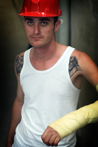 Tattooed man in plaster