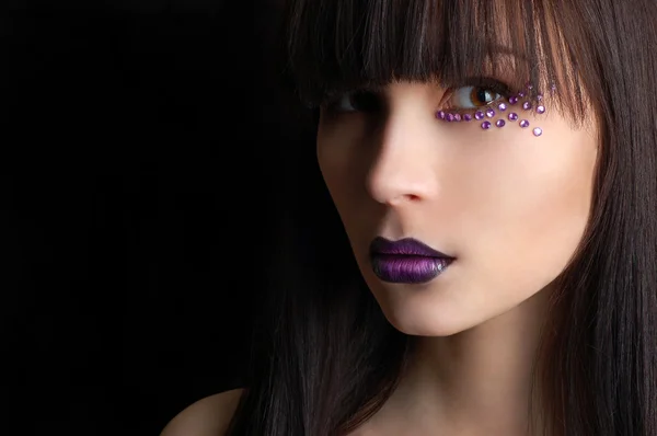 Beautiful woman with violet make-up