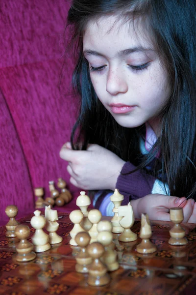 Little girl play chess game