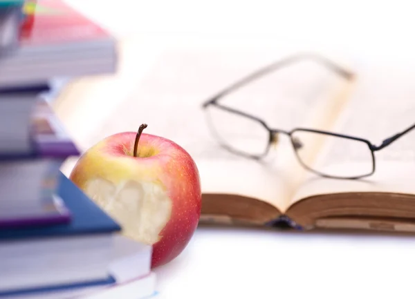 Books, apple and glasses