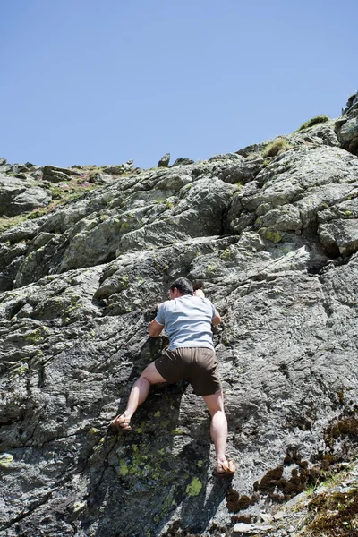 Strong man climbing mountain